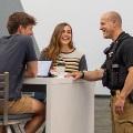 OfficertalkingtostudentsintheStevenStudentCenter